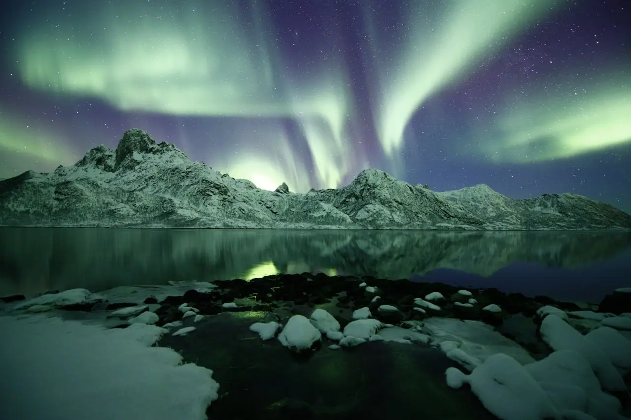 Northern Lights aurora borealis over snowy landscape